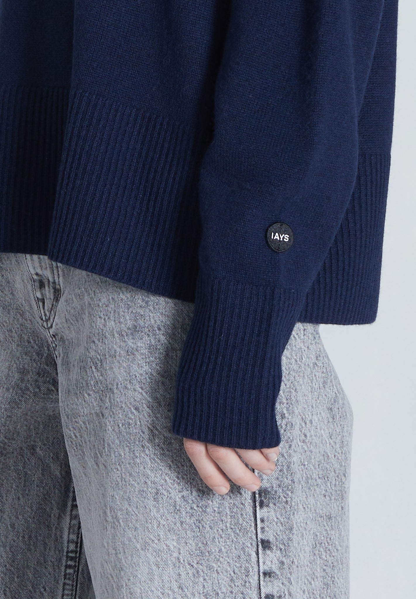 Close up of sleeve of navy cashmere sweater