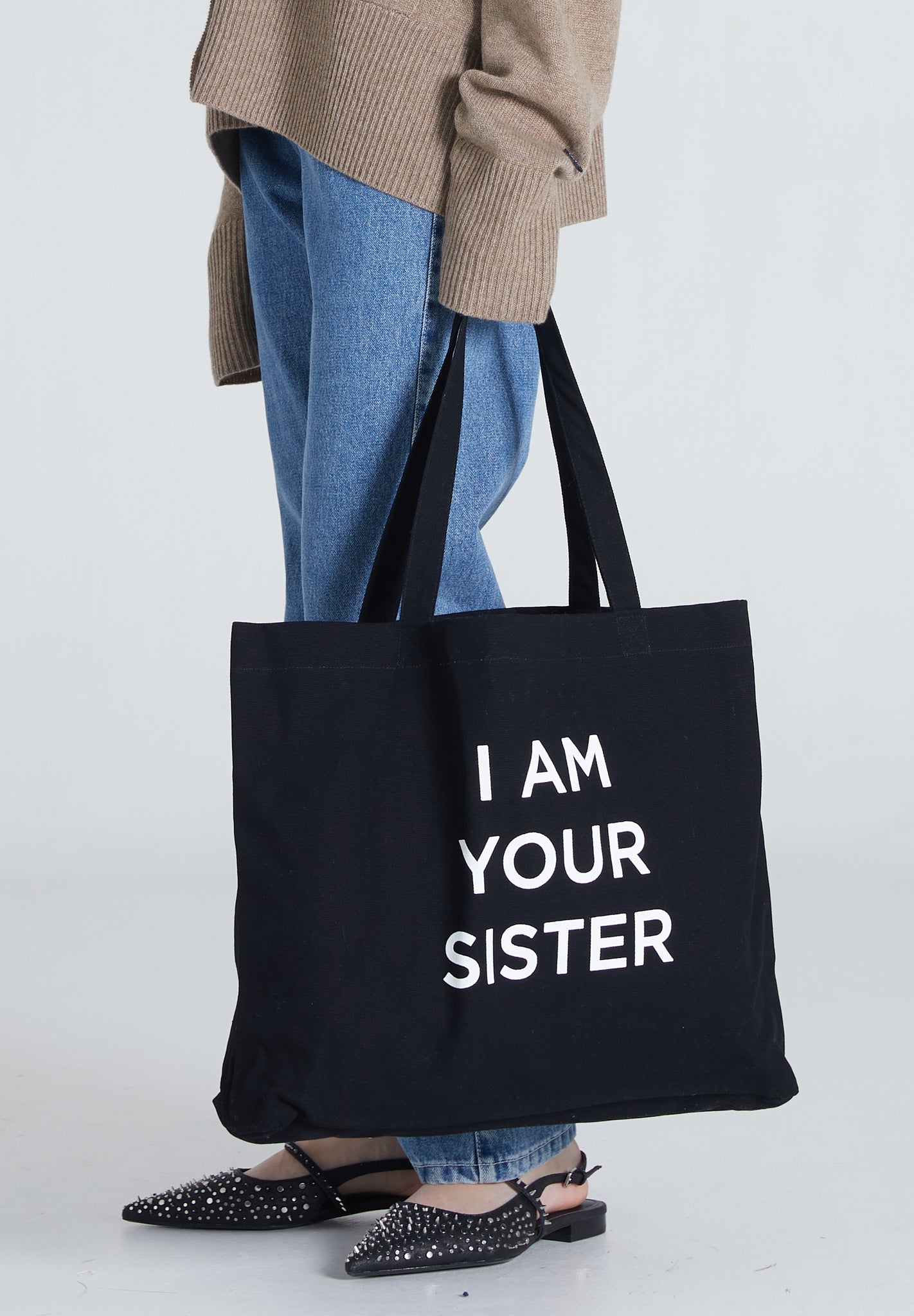 Black Tote Bag with print saying I AM YOUR SISTER
