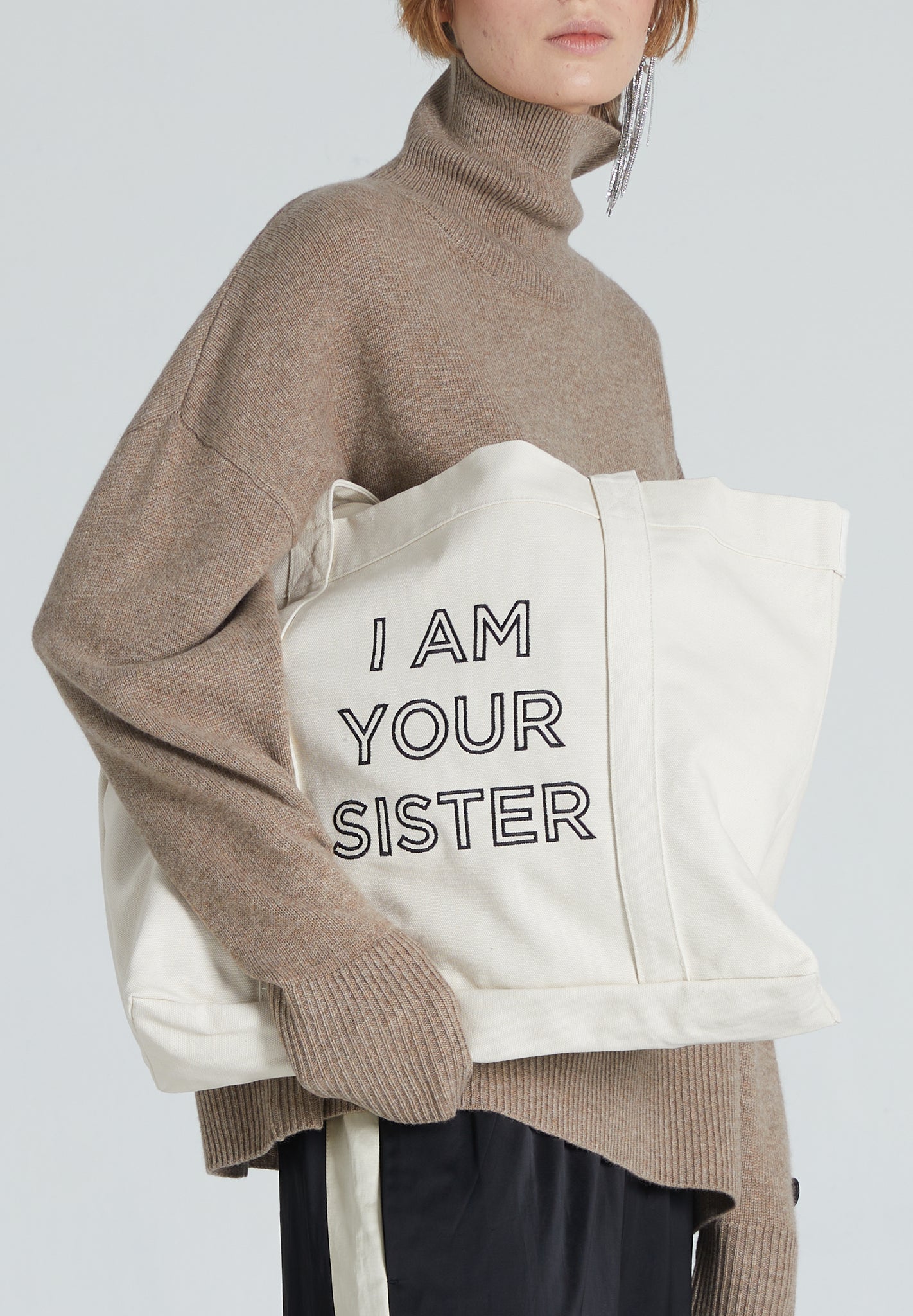 Tote bag with embroidered statement sayin I AM YOUR SISTER 