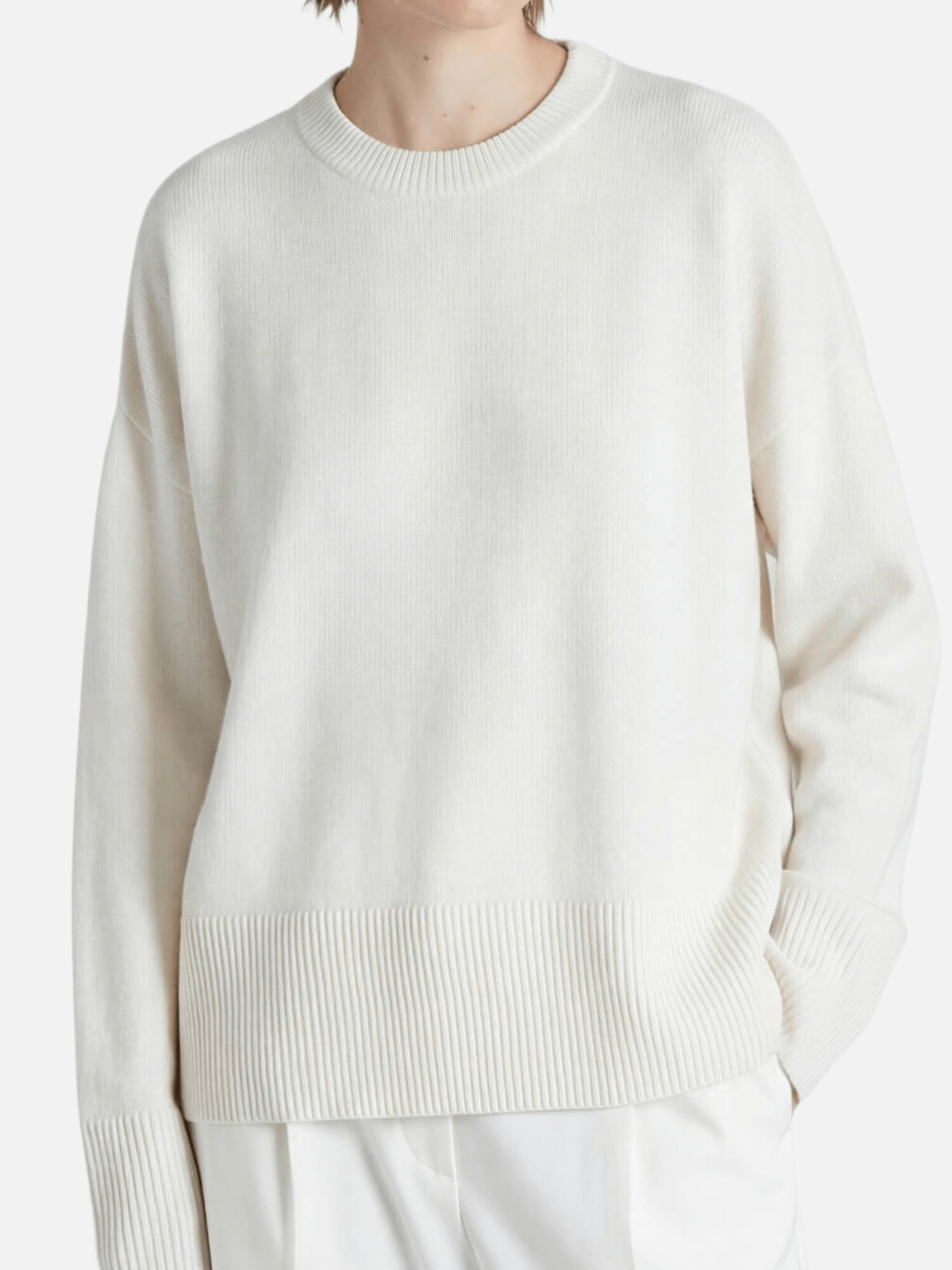 White sweater worn by a person on a white background